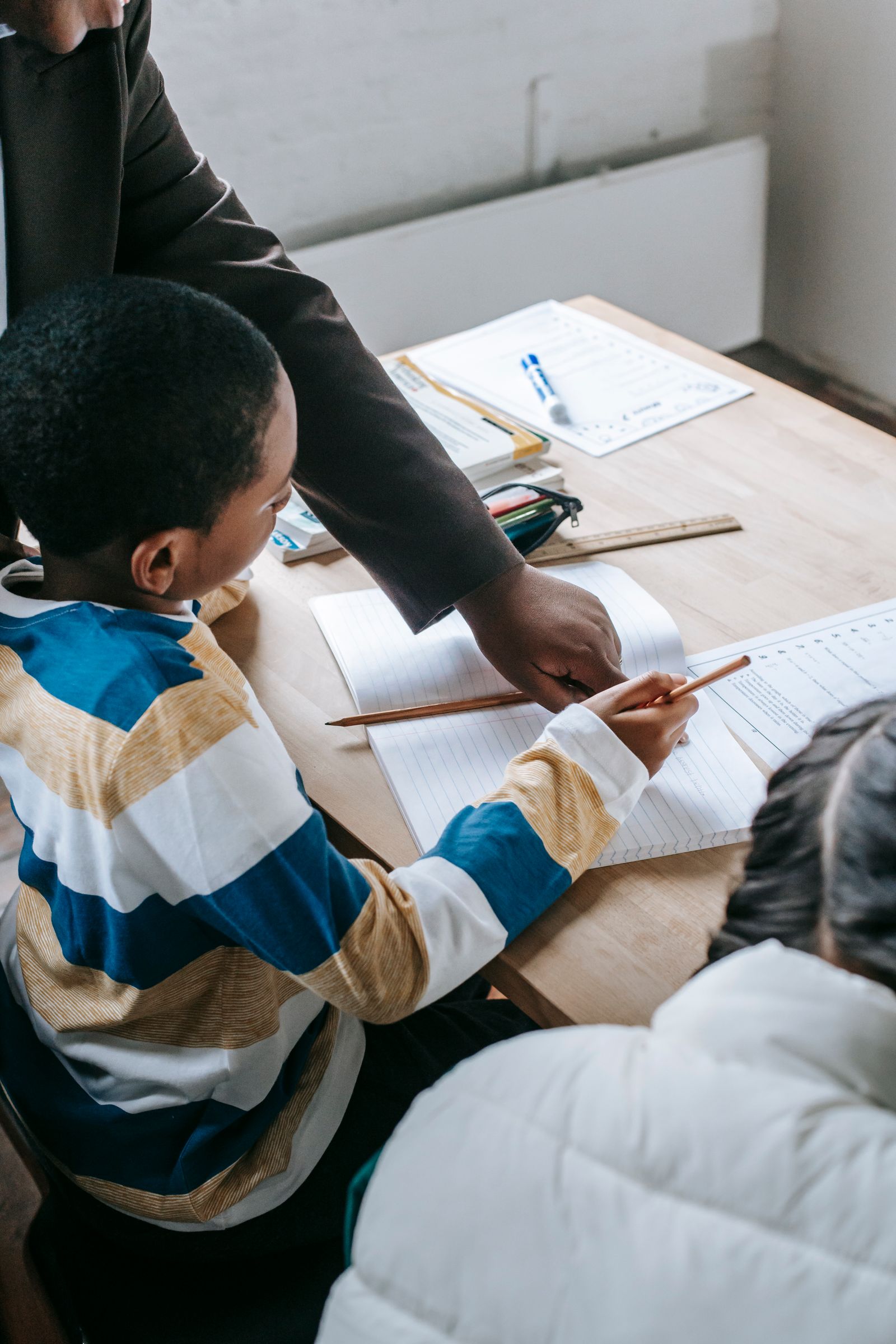An educator supporting a student with schoolwork
